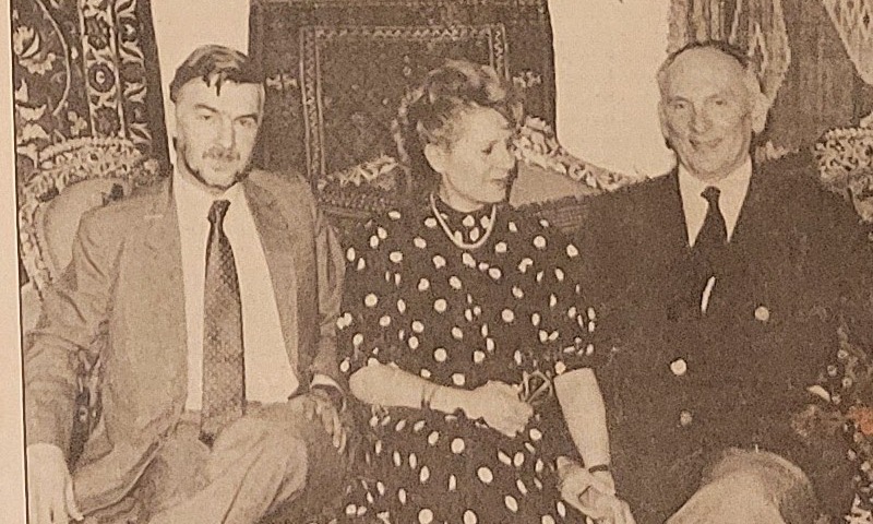 Nabi Israfil on the left, his wife Izabella Israfil in the centre, and Professor Zdzislaw Zygulski Jr. on the right, seated together on a carved antique bench with rugs hanging behind them.