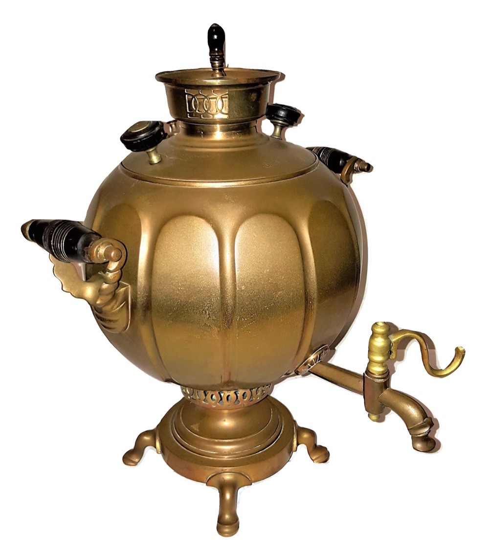 A Russian brass samovar of the nineteenth century, made in Tula: a round lobed body on a stepped foot, turned black wooden handles, a tap with a curled brass key, and a pierced crown at the top.