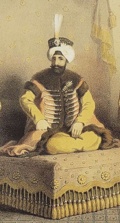 Ottoman chromolithograph of Sultan Mahmud II enthroned on a fringed divan, in a white turban with a jewelled plume and a fur-trimmed robe over a gold kaftan, from Arif Pasha's Costumes de l'Empire Ottoman, Paris, 1863